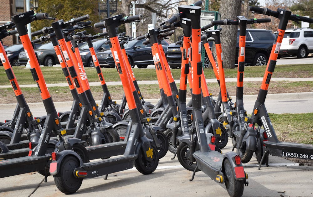 Spin scooters line the streets of Circle Drive on April 5, 2022. 