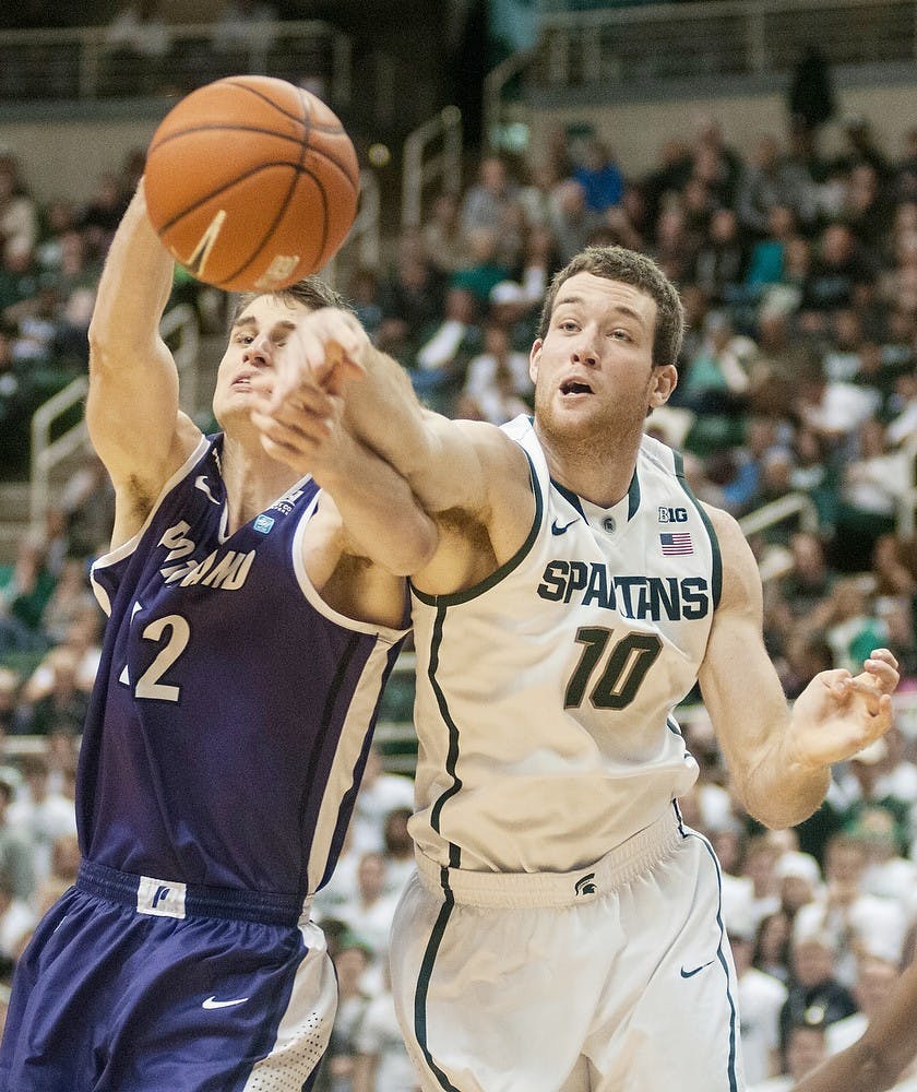 	<p>Sophomore forward Matt Costello tries to steal the ball from Portland center Thomas van der Mars on Nov. 18, 2013, at Breslin Center. The Spartans defeated the Pilots, 82-67. Danyelle Morrow/The State News</p>