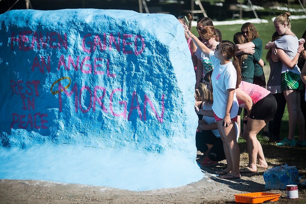 <p>People line up to sign their names on The Rock Sept. 28, 2014, during McGregor's memorial at The Rock on Farm Lane. The cause of death is currently unknown. Erin Hampton/The State News</p>
