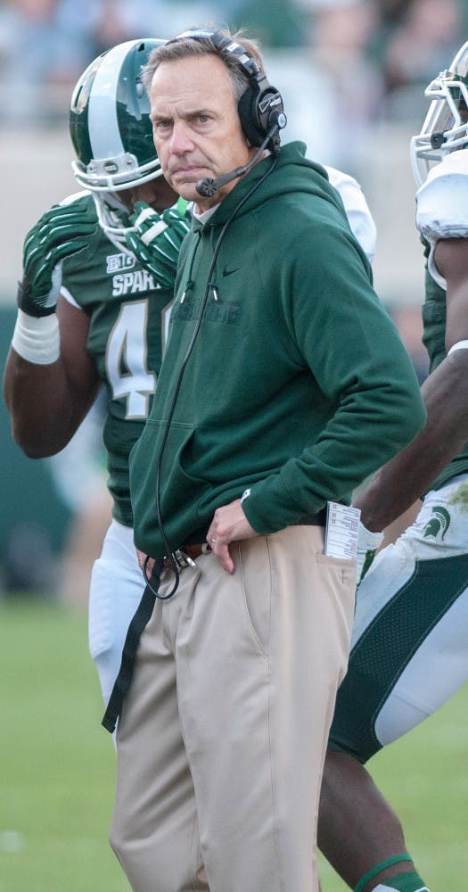 Head coach Mark Dantonio looks at the scoreboards after a time out  on Saturday afternoon, Sept. 22, 2012, at Spartan Stadium. MSU won against Eastern Michigan 23-7. Natalie Kolb/The State News