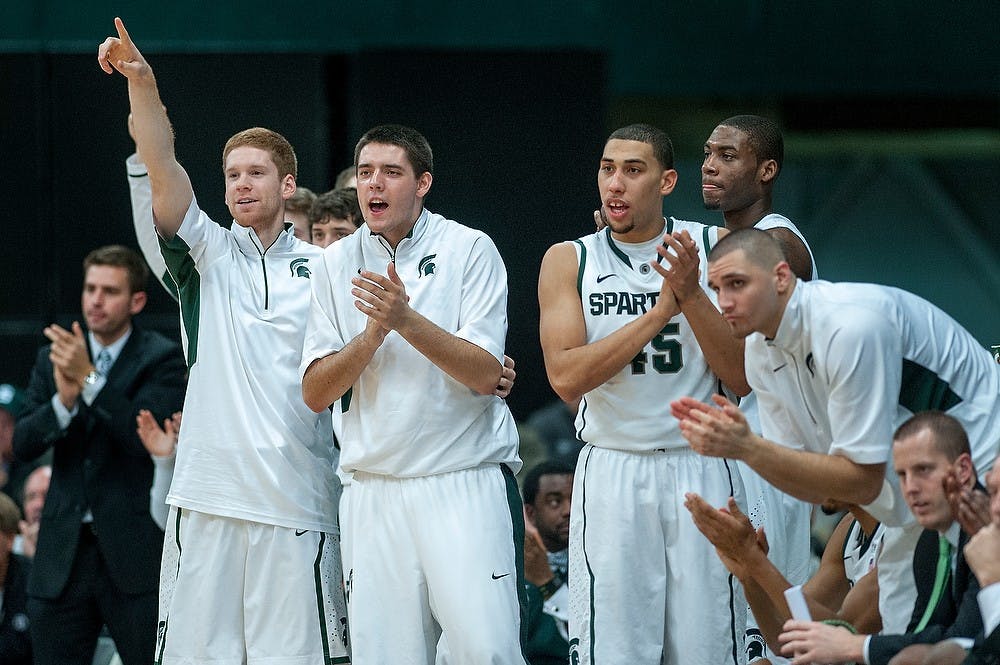 	<p>Spartan players cheer for freshman forward Matt Costello after he gained a favorable foul call. The Spartans defeated the Golden Tigers, 92-56, Saturday, Dec. 15, 2012, at Jenison Field House. Justin Wan/The State News</p>