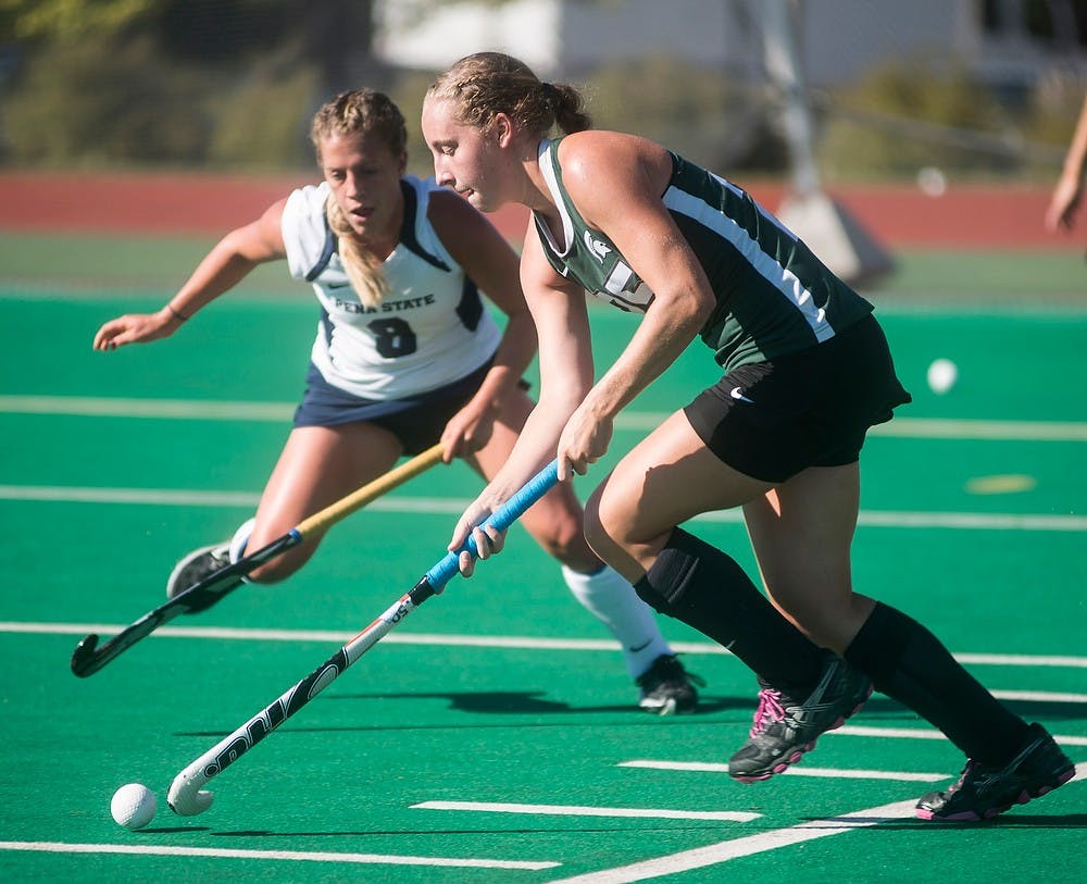 <p>Sophomore midfielder Kristin Matula runs the ball down the field past Penn State forward/midfielder Taylor Herold Sept. 26, 2014, at Ralph Young Field. The Spartans were defeated by the Nittany Lions, 2-1. Erin Hampton/The State News</p>