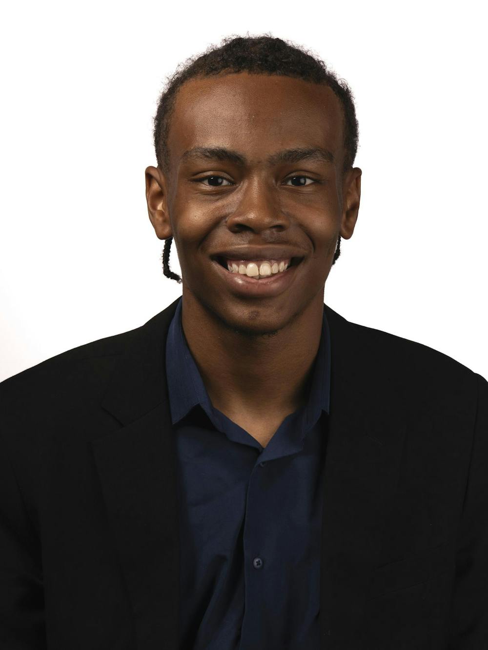A staff member poses for a headshot at The State News office on Thursday, Sept. 3, 2026, in East Lansing, Michigan.