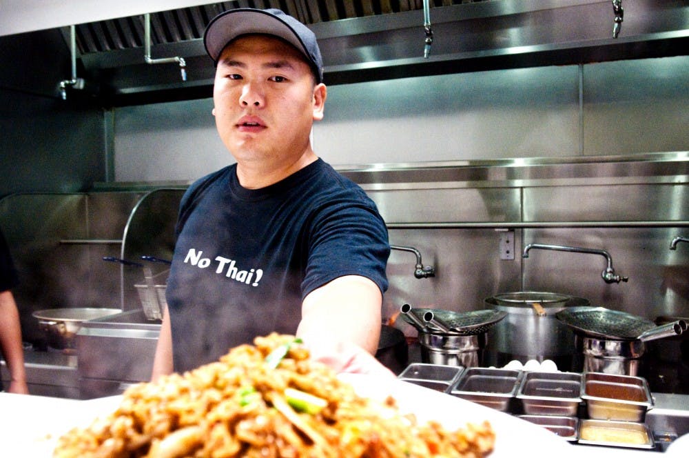 	<p>No Thai! employee Josh Hang serves up a plate of fried rice for a dine in customer Monday afternoon at the East Lansing location of the Michigan based Thai food chain, 403 East Grand River Ave. Despite the <span class="caps">MSU</span> roots of three out of four owners of No Thai! the resturant, which currently has three Ann Arbor locations, just opened shop on Grand River last Wednesday.</p>