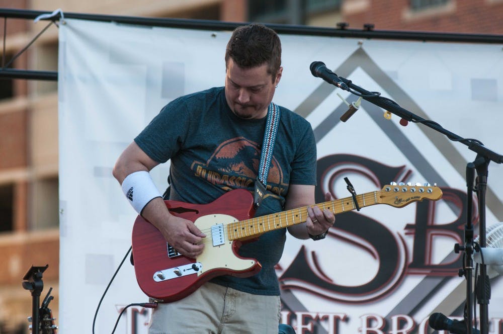 Lead guitar, mandolin, banjo, bass, vocals and percussionist Mark Collins plays at the East Lansing Summer Concert Series on July 6, 2018.