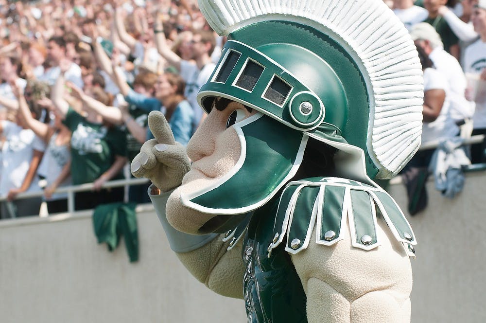 <p>Sparty cheers on the MSU football team during the game against Eastern Michigan on Sept. 20, 2014, at Spartan Stadium. The Spartans defeated the Eagles, 73-14. Raymond Williams/The State News</p>