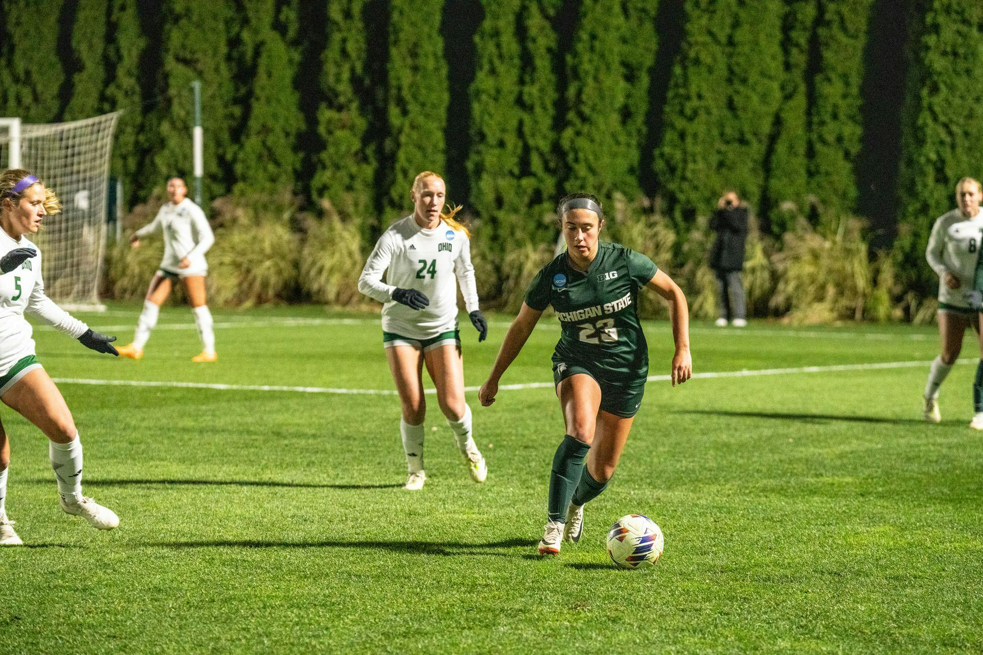 <p>Michigan State University freshman forward Bella Najera (23) with the ball while her Ohio University opponents senior midfielder Carsyn Prigge (24) tailing behind her at the NCAA first tournament at DeMartin Soccer Complex on Nov. 10th, 2023. </p>