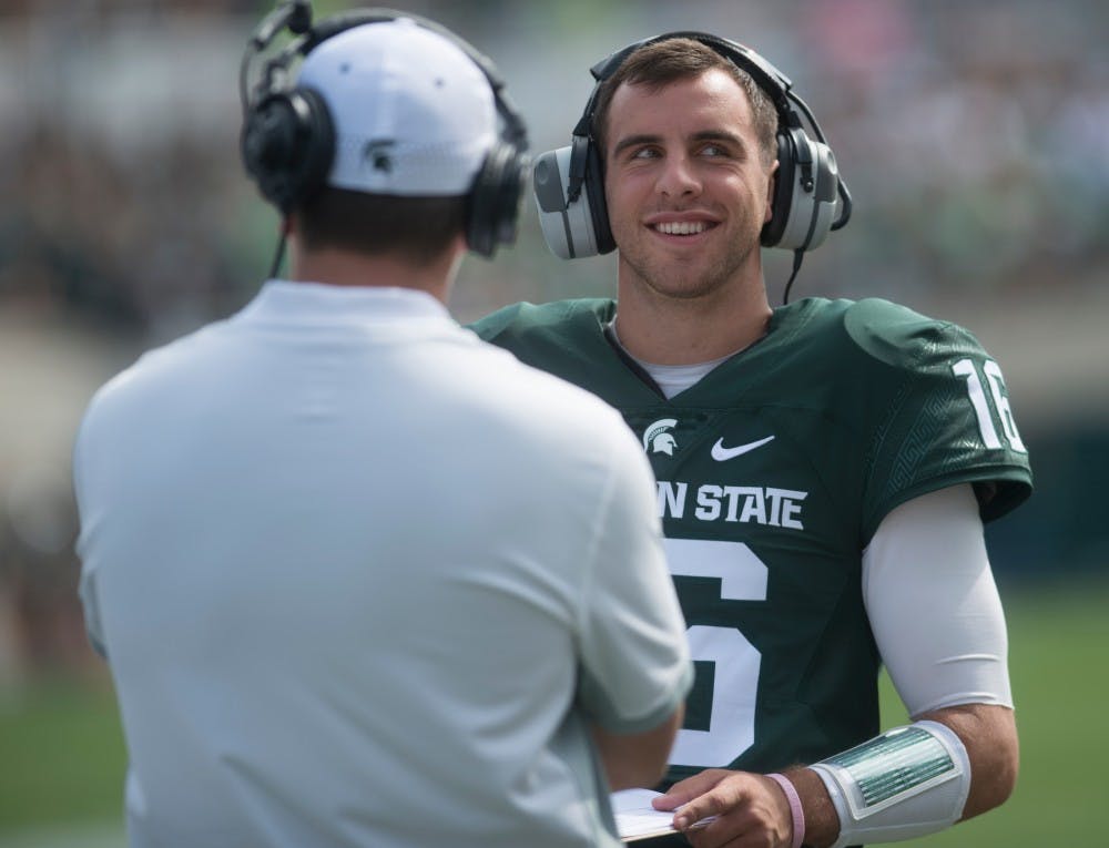 <p>Fourth string senior quarterback Tony Vento speaks with a coach during the game against Central Michigan on Sept. 26, 2015, at Spartan Stadium. The Spartans defeated the Chippewas, 30-10. Alice Kole/The State News</p>