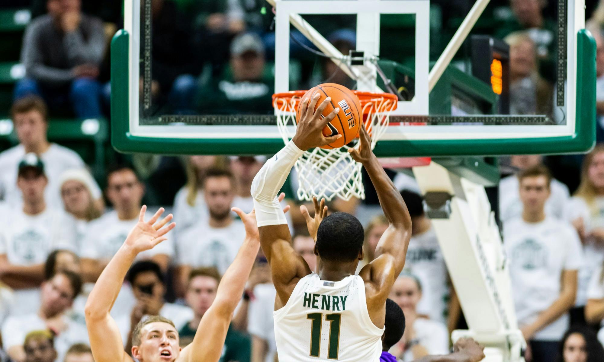 <p>Sophomore forward Aaron Henry (11) dunks over Albion defenders. The Spartans defeated the Britons, 85-50, on Oct. 29, 2019 at the Breslin Student Events Center.</p>