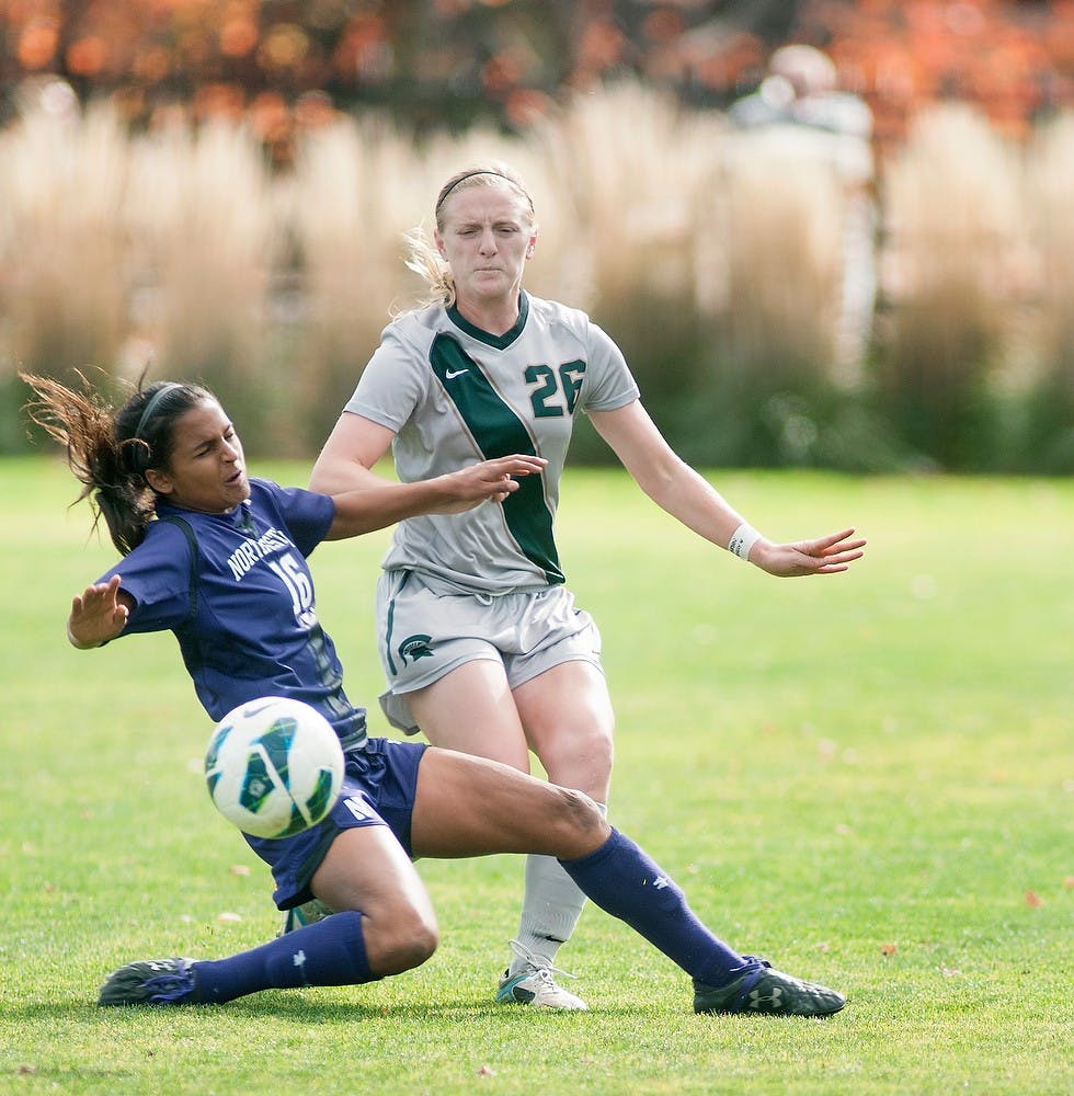 Senior defender Desiree Aber goes up against Penn State's midfielder/defender Nandi Mehta on Oct. 27, 2012, at DeMartin Stadium. The Wildcats defeated the Spartans 1-0. Natalie Kolb/The State News