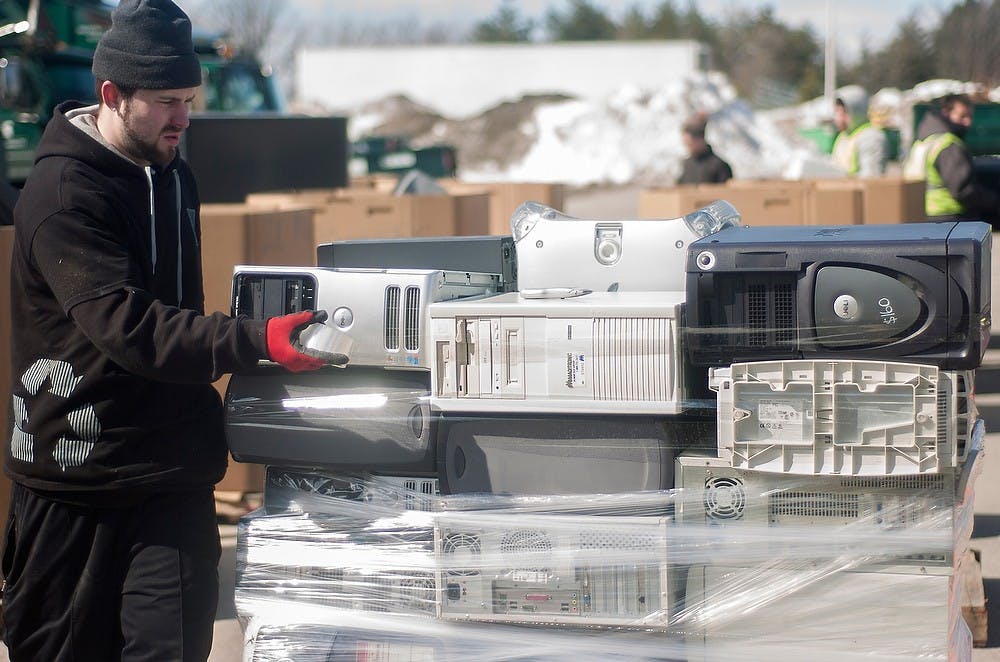 <p>Romulus, Mich., resident Jon Hawbaker works at the MSU Free Electronic Recycling event on March 14, 2014, at the MSU Surplus Store. People brought out old electronics to be recycled. Erik Sargent/The State News</p>