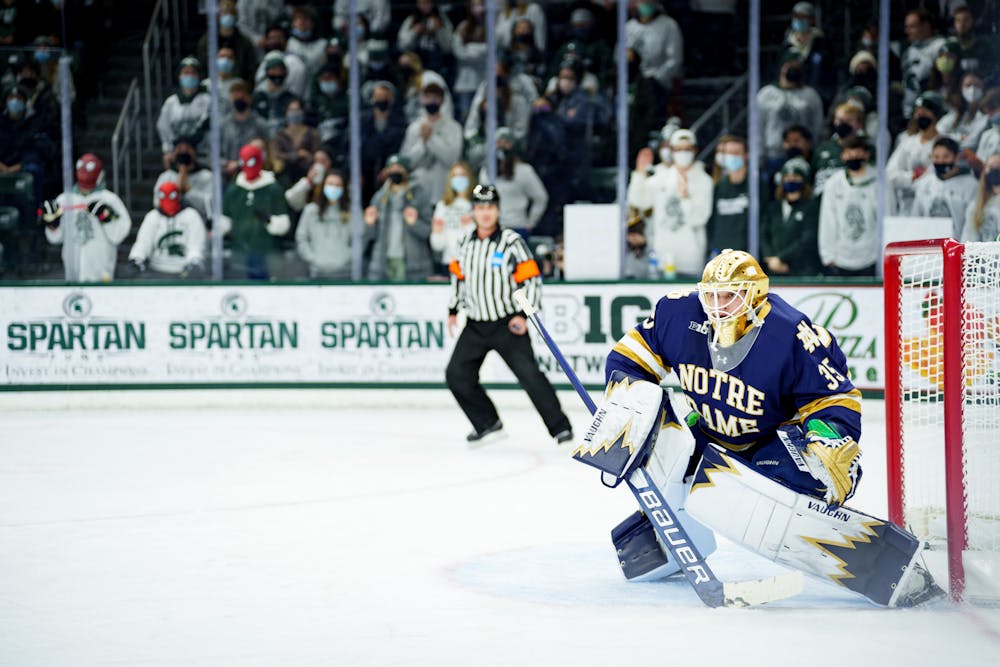 <p>Notre Dame graduate student Matthew Galajda watching the puck with three spidermen seen in the background located in the Michigan State student section on Feb. 19, 2022. Spartans lost 4-2 against Notre Dame.</p>