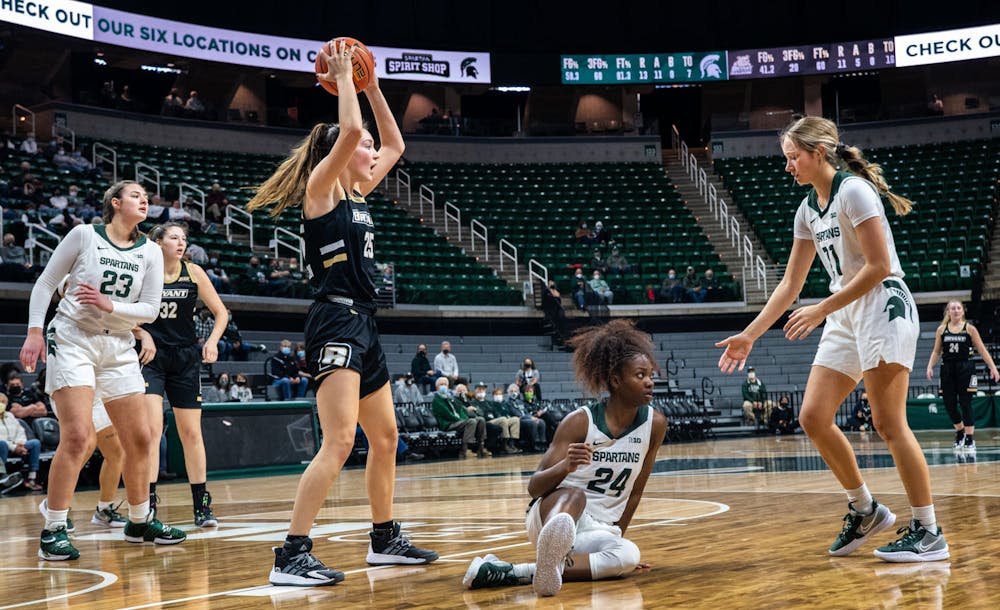 <p>Players look to the referees after Bryant&#x27;s Juliette Golden knocks senior guard Nia Clouden (24) onto the court in the second quarter. The Spartans crushed the Bulldogs, 100-60, which led coach Suzy Merchant to her 300th win with Michigan State on Nov. 19, 2021.</p>