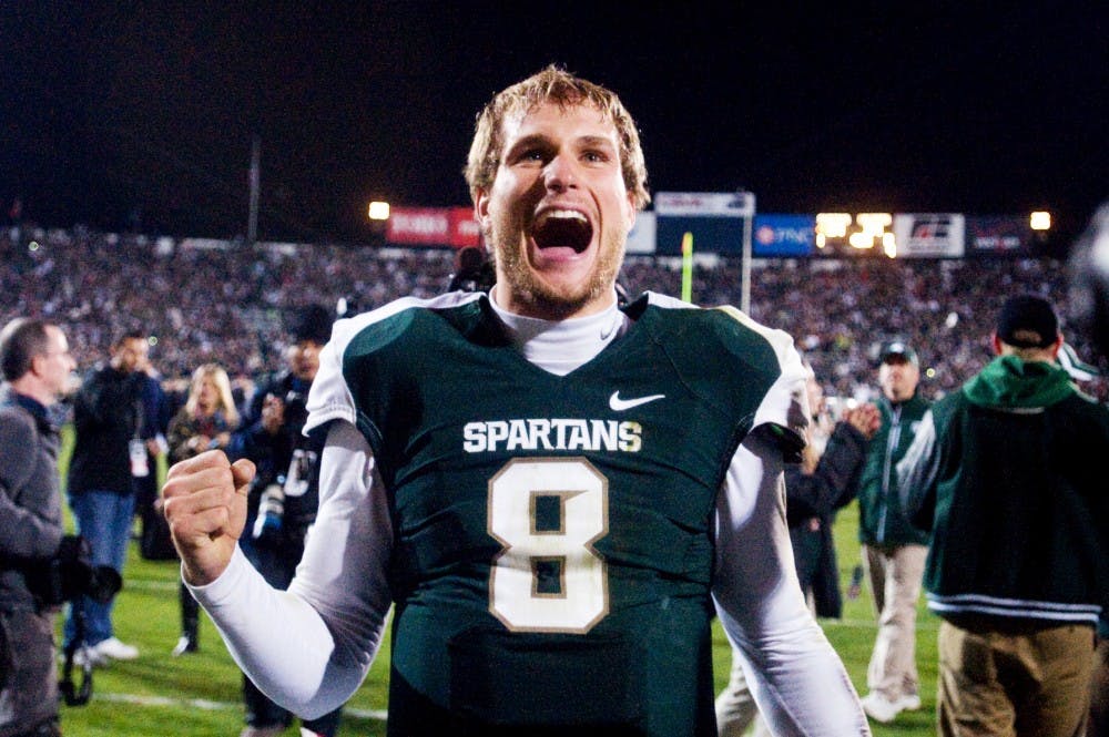 Senior quarterback Kirk Cousins celebrates the Spartans' victory Saturday at Spartan Stadium. The Spartans defeated the Wisconsin Badgers 37-31. Matt Radick/The State News