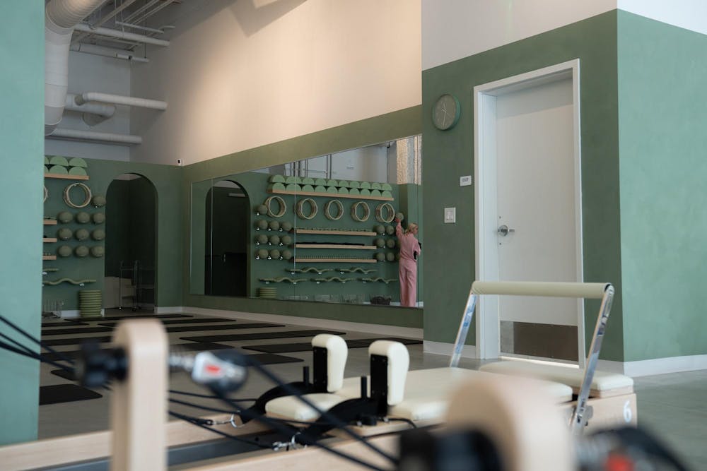 Olivia Harris stocks equipment at Recharged Pilates on June 12, 2025. 