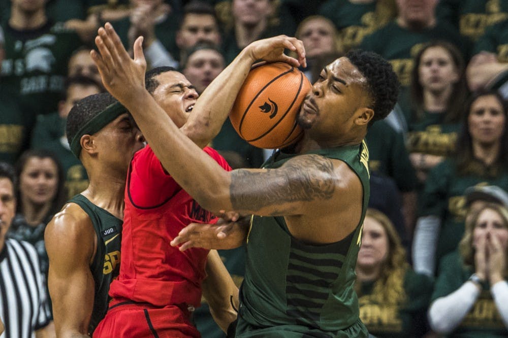 Maryland guard Anthony Cowan Jr. (1) collides with sophomore forward Nick Ward (44) during the men's basketball game against Maryland on Jan. 4, 2018 at Breslin Center. The Spartans defeated the Terrapins, 91-61. (Nic Antaya | The State News)