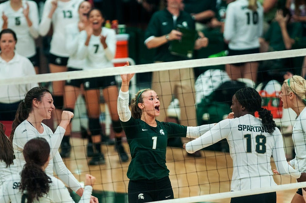 	<p>Junior libero Kori Moster celebrates with teammates after a point is scored during their game against Oregon, Sept. 6, 2013, at Jenison Field House. The Spartans defeated Oregon, 3-1. Danyelle Morrow/The State News</p>