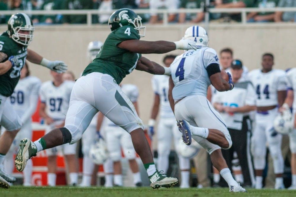 Junior defensive lineman Malik McDowell (4) reaches his arms out for a tackle against Furman running back Richard Hayes III (4) during the home football game against Furman on Sept. 2, 2016 at Spartan Stadium. The Spartans defeated the Paladins, 28-13.