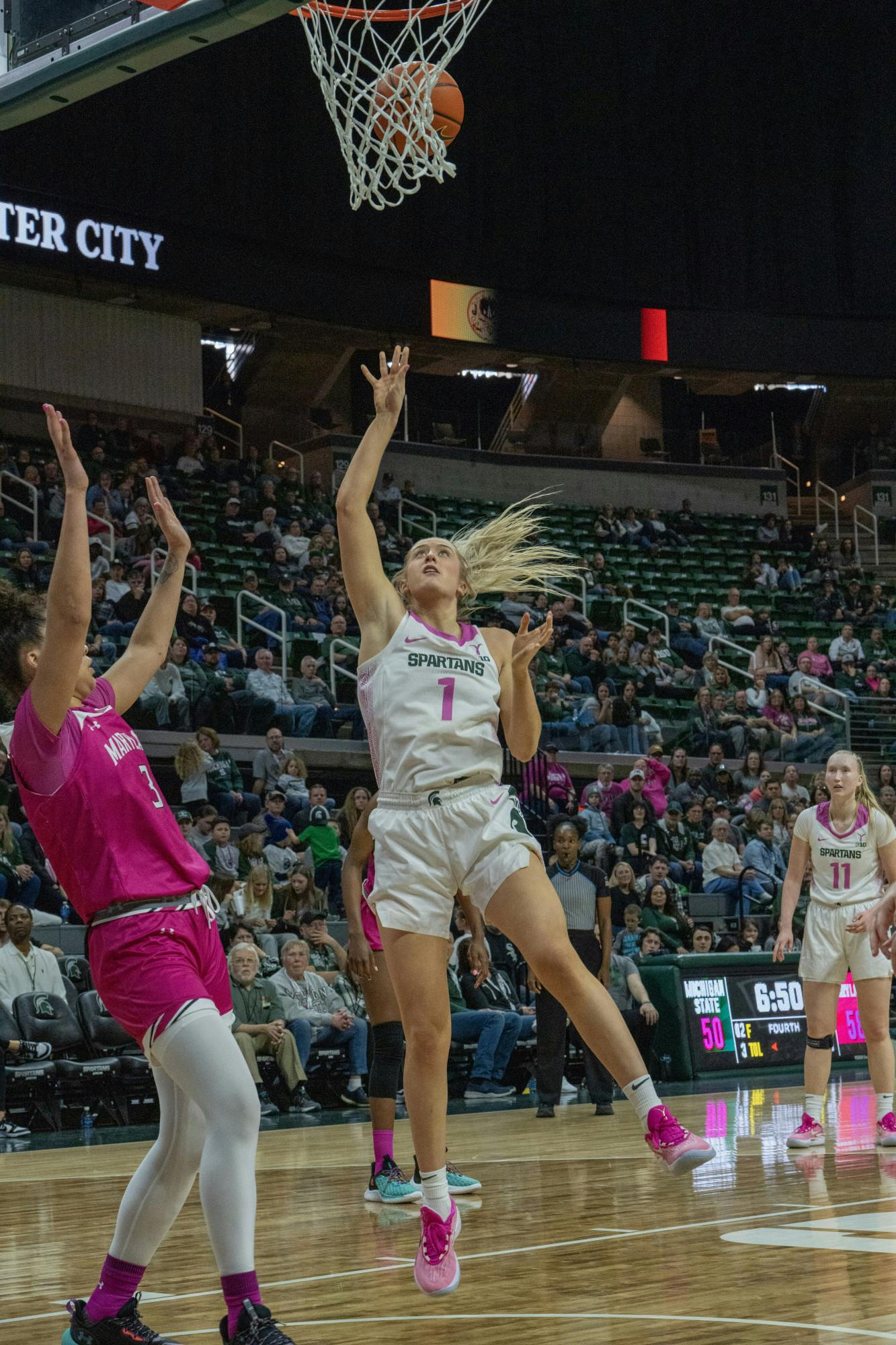 <p>Senior guard Tory Ozment scores against Maryland on Feb. 18, 2023.</p>