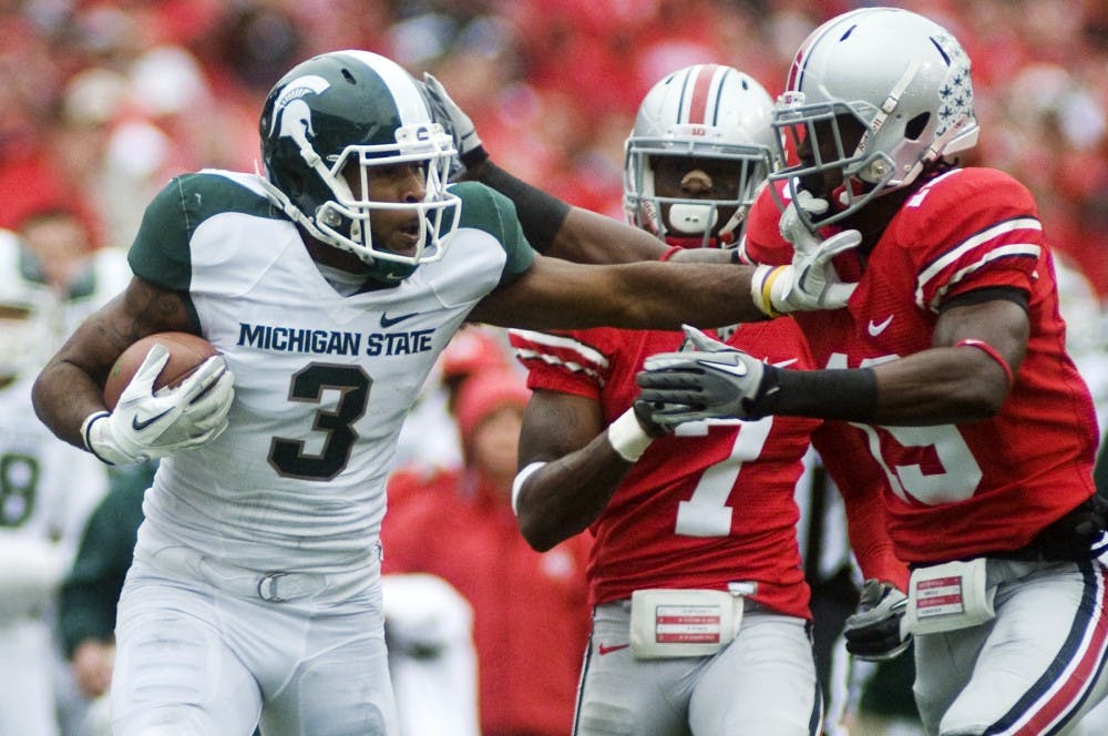 Senior wide receiver B.J. Cunningham runs the ball after completing a pass for 52 yards as Ohio State defensive back Orhian Johnson attempts to push him out of bounds during Saturday's game at Ohio Stadium in Columbus, Ohio. Lauren Wood/The State News