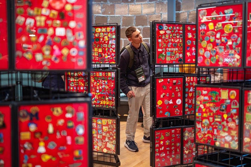 A competitor at the 2025 Odyssey of the Minds browses pins for trade/sale at the Michigan State STEM Building in East Lansing, Michigan on May 22, 2025. 