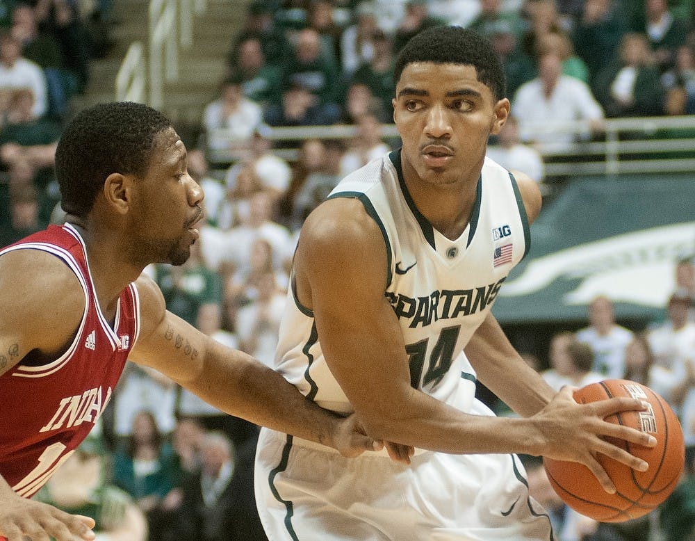 	<p>Sophomore guard Gary Harris looks around Indiana guard Evan Gordon to pass Jan. 21, 2014, at Breslin Center. The Spartans defeated the Hoosiers, 71-66. Julia Nagy/The State News</p>