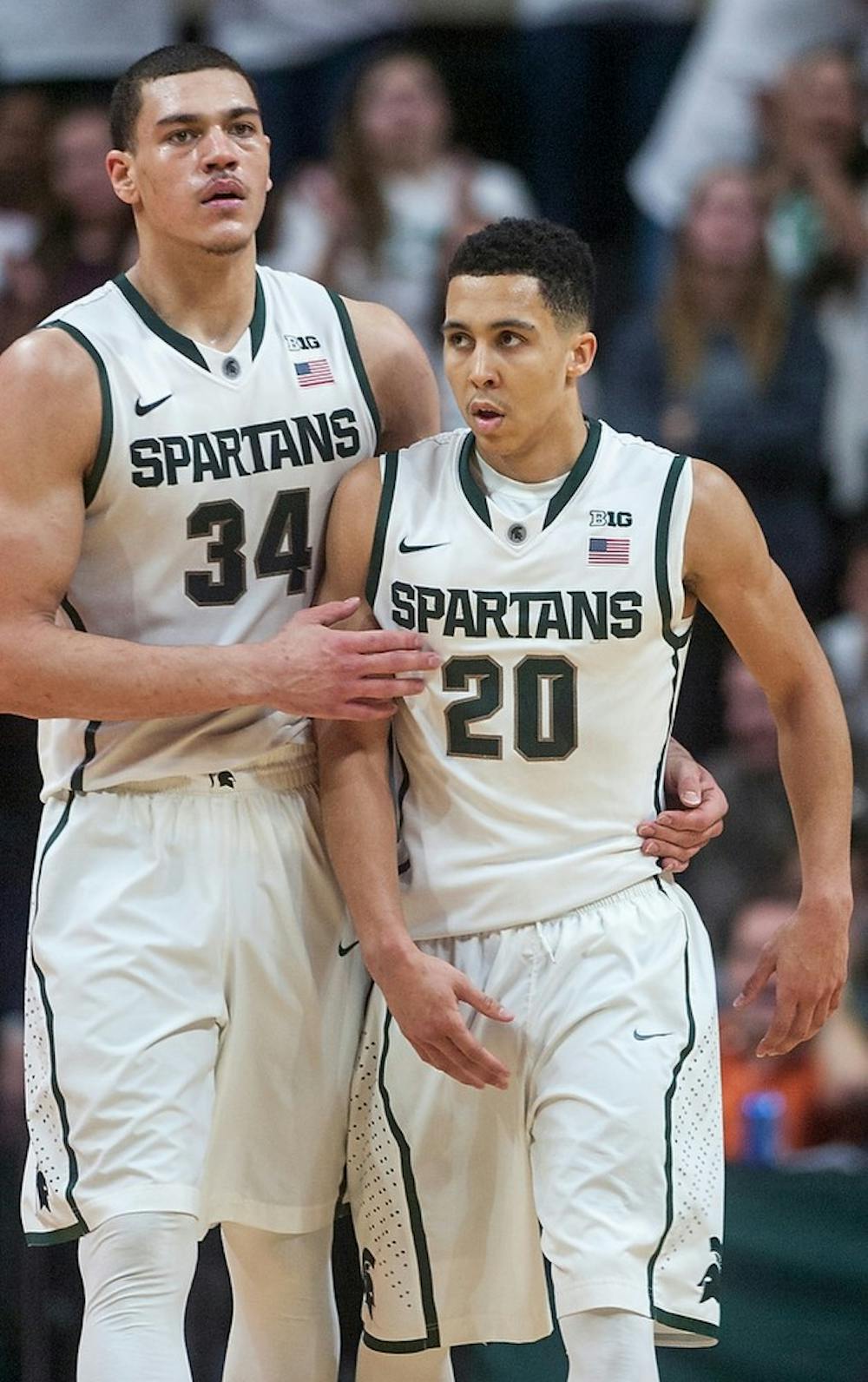 <p>Sophomore forward Gavin Schilling consoles senior guard Travis Trice after a foul call Jan. 11, 2015, during the game against Northwestern at Breslin Center. The Spartans defeated the Wildcats, 84-77 in overtime. Kelsey Feldpausch/The State News.</p>