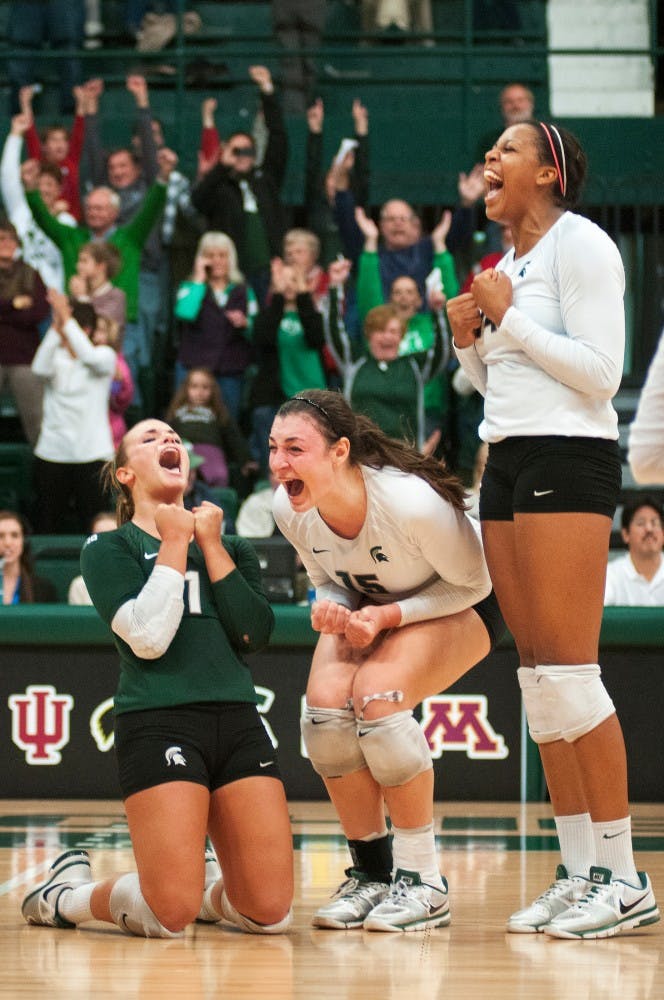 From left, sophomore libero Kori Moster, junior outside hitter Lauren Wicinski, and sophomore middle blocker and outside hitter Jazmine White celebrate after scoring the match winning point on Friday, Nov. 9, 2012, at Jenison Fieldhouse. MSU defeated Minnesota 3-1. James Ristau/The State News