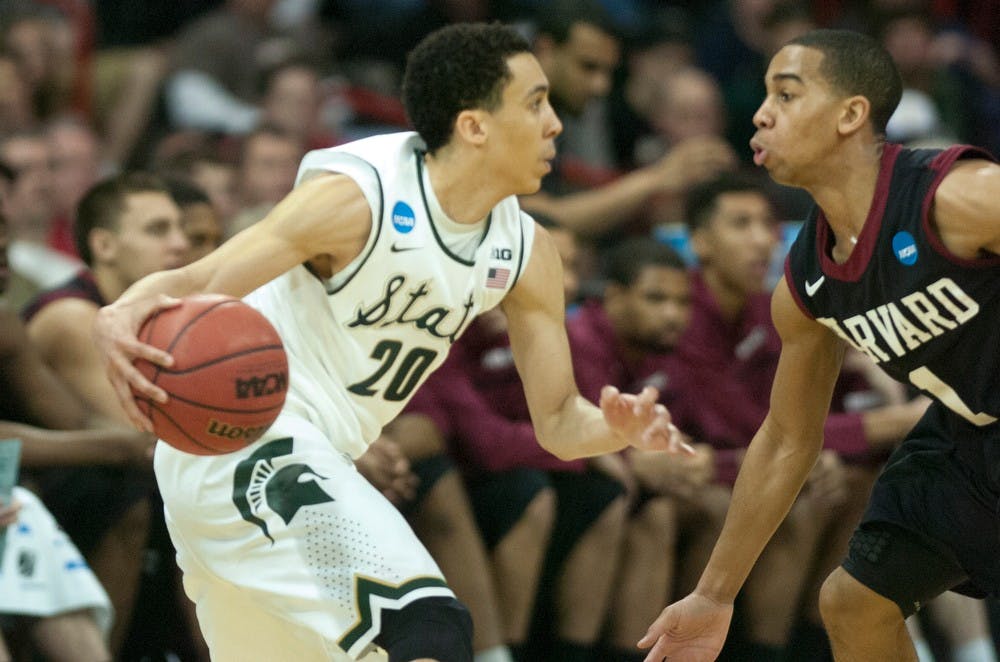 <p>Junior guard Travis Trice dribbles while Harvard guard Siyani Chambers guards on March 22, 2014, at Spokane Veterans Memorial Arena in Spokane, Wash. during the NCAA Tournament. The Spartans won, 80-73. Betsy Agosta/The State News</p>