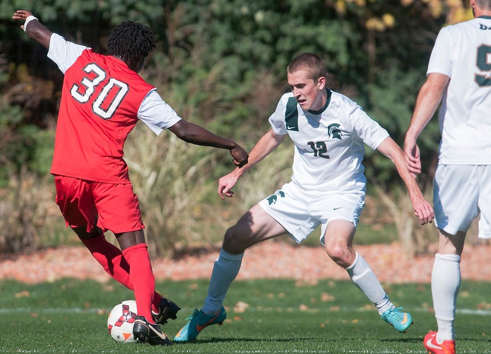 	<p>Ohio State midfielder Kofi Aqyapong fights for control of the ball against redshirt freshman defender Andrew Herr on Oct. 13, 2013, at DeMartin Stadium at Old College Field. The Spartans tied the Buckeyes, 1-1. Georgina De Moya/The State News</p>