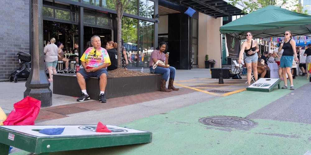 <p>East Lansing Pride attendees play cornhole on a closed off Albert Ave in East Lansing, Mich., on June 13, 2026.</p>