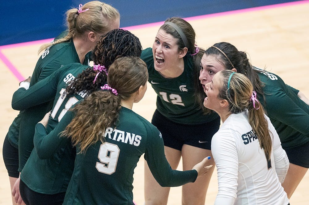 	<p><span class="caps">MSU</span> volleyball players huddle together as junior setter Kristen Kelsay pumps up the team Wednesday night, Oct. 17, 2012, at Cliff Keen Arena in Ann Arbor, Mich. The Spartans defeated the Michigan Wolverines in three straight sets (25-20, 25-17, 25-20). Adam Toolin/The State News</p>