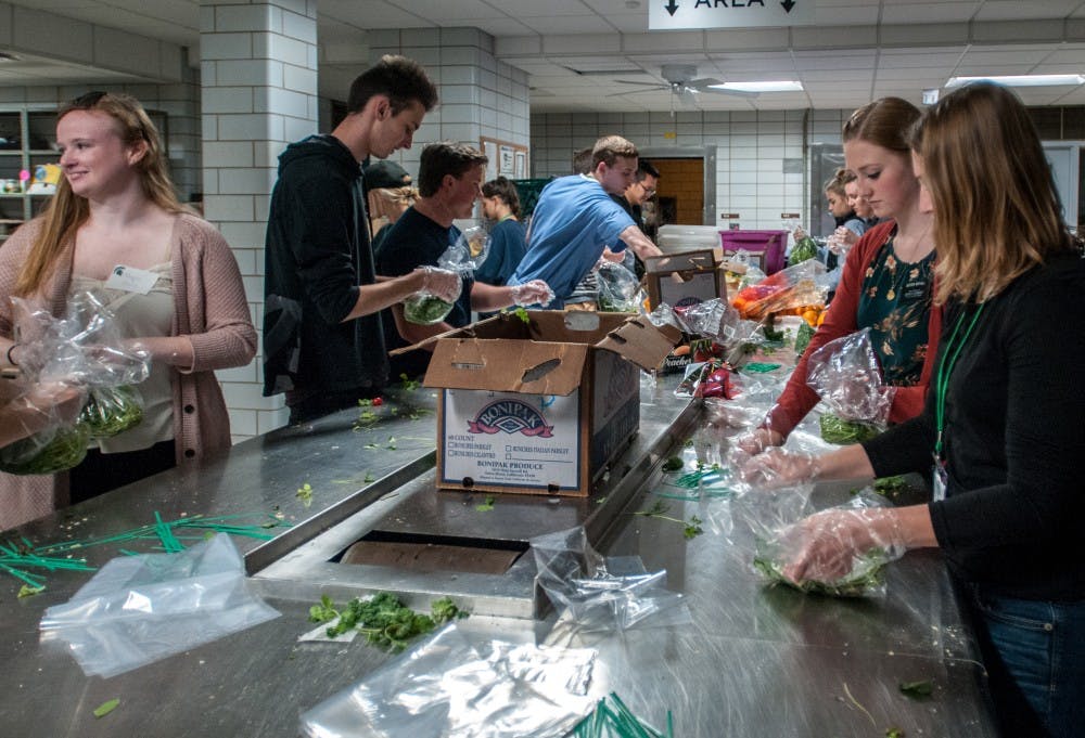 Volunteers work together to package parsley for the MSU Food Bank on Oct. 17, 2018 at Olin Heath Center.