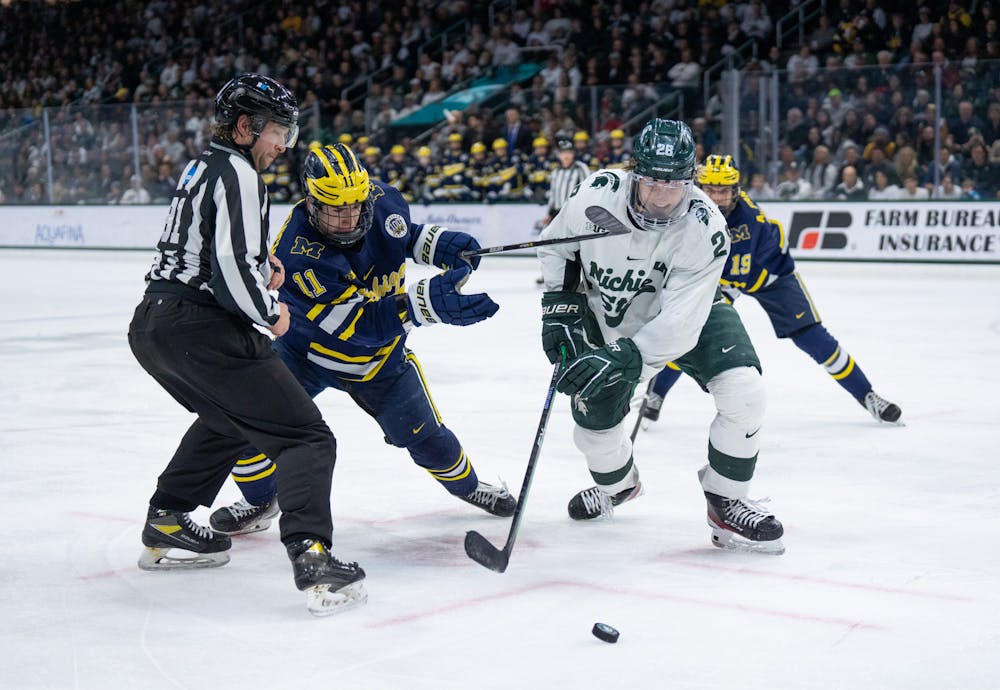 <p>Michigan sophomore Mackie Samoskevich (left) and MSU freshman Karsen Dorwart battle for the puck after a faceoff at Munn Ice Arena on Friday, February 10, 2023. The Wolverines maintained a 3-2 lead over the Spartans at the conclusion of the second period.</p>