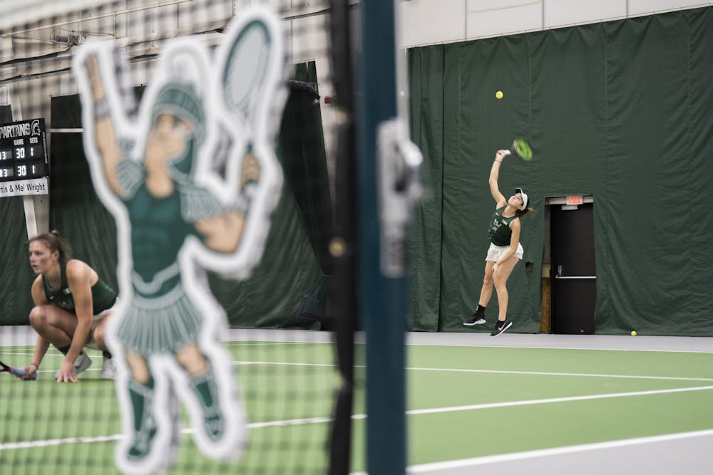 MSU sophomore Matilde Morais serves in the doubles match with MSU sophomore Issey Purser against Purdue's Carmen Gallardo Guevara and Tara Katarina Milic at the MSU Tennis Facility on March 30.