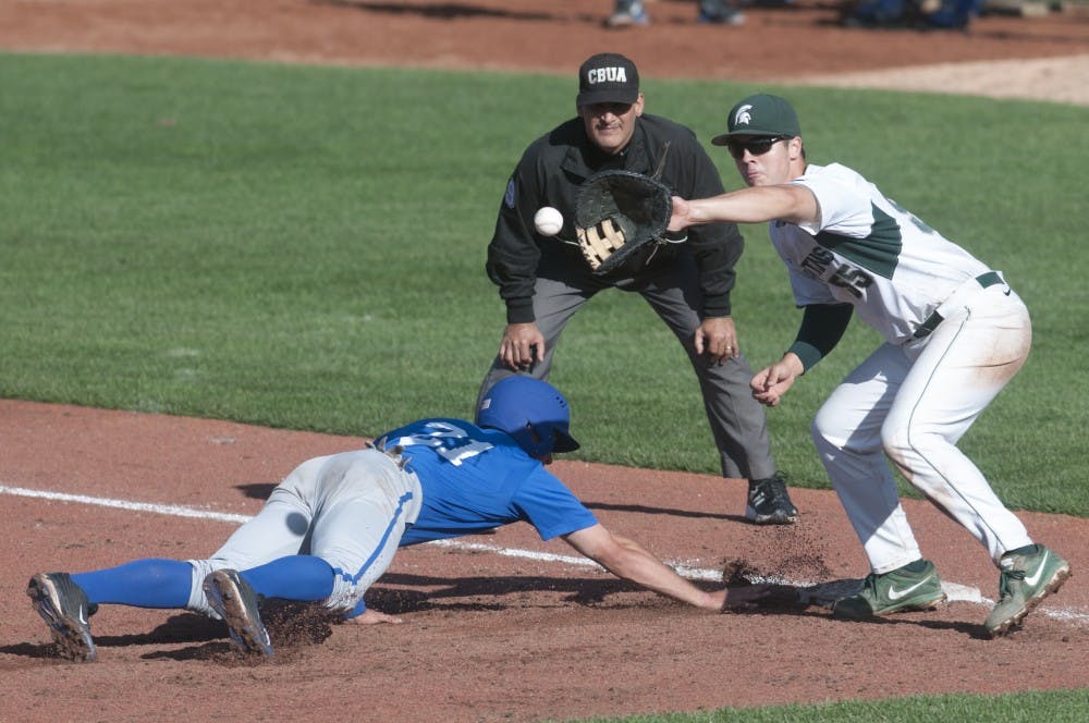 <p>Air Force pitcher Ben Yokley dives for safety while sophomore infielder Zack McGuire attempts a catch during the baseball exhibition game against Air Force  on Sept. 19, 2015 at McLane Stadium. MSU baseball season begins in February. Jack Stephan/The State News</p>