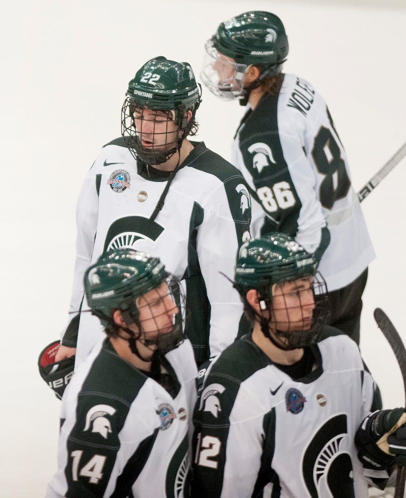 	<p>Junior forward Lee Reimer, 22, waits along with freshman forward Ryan Keller, 12, junior defenseman Nickolas Gatt, 14, and junior forward Greg Wolfe, 86, to shake hands with opposing Notre Dame players Friday, Jan. 11, 2013, at Munn Ice Arena after losing 1-0. Danyelle Morrow/The State News</p>