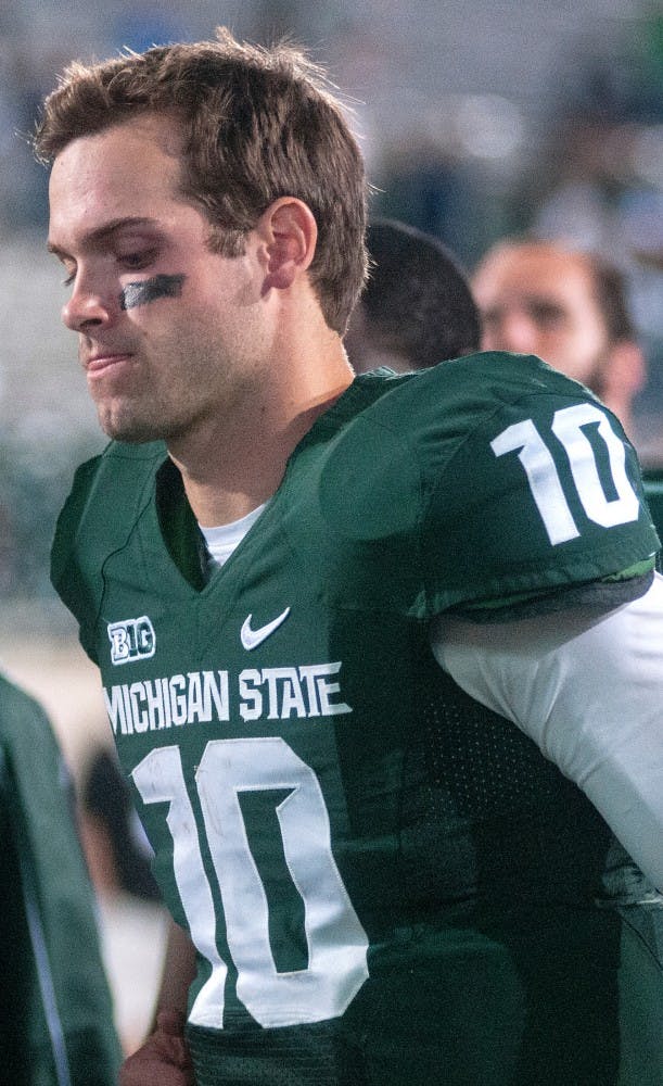 Junior quarterback Andrew Maxwell walks off the field Saturday night, Sept. 15, 2012 at Spartan Stadium. The Spartans were given their first loss of the season as Notre Dame defeated MSU 20-3. Adam Toolin/The State News