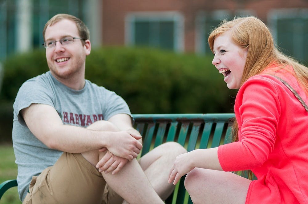 <p>Music education junior Marcus McGuire and music education freshman Colleen Morence laugh while participating in a speed dating event as part of a pride picnic hosted by Spectrum and PRIDE on April 12, 2014, at the courtyard by the Student Services Building. The event was one of many featured during Pride Week. Danyelle Morrow/The State News</p>