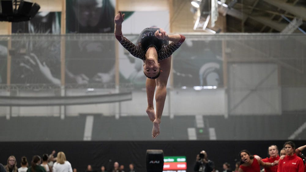 Chelsey Dennis, junior from Maryland, performs back aerials on the balance beam during the MSU tri-meet at Jenison Field House on Sunday, Feb. 15, 2026