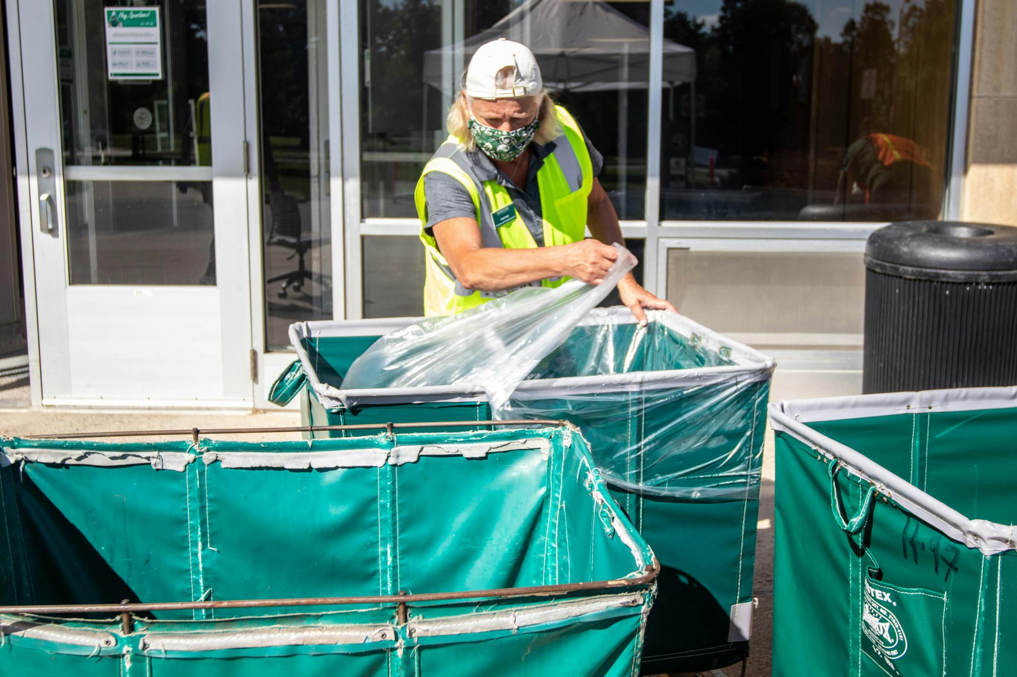 People sanitize carts at Wilson Hall during move in Aug. 31, 2020.