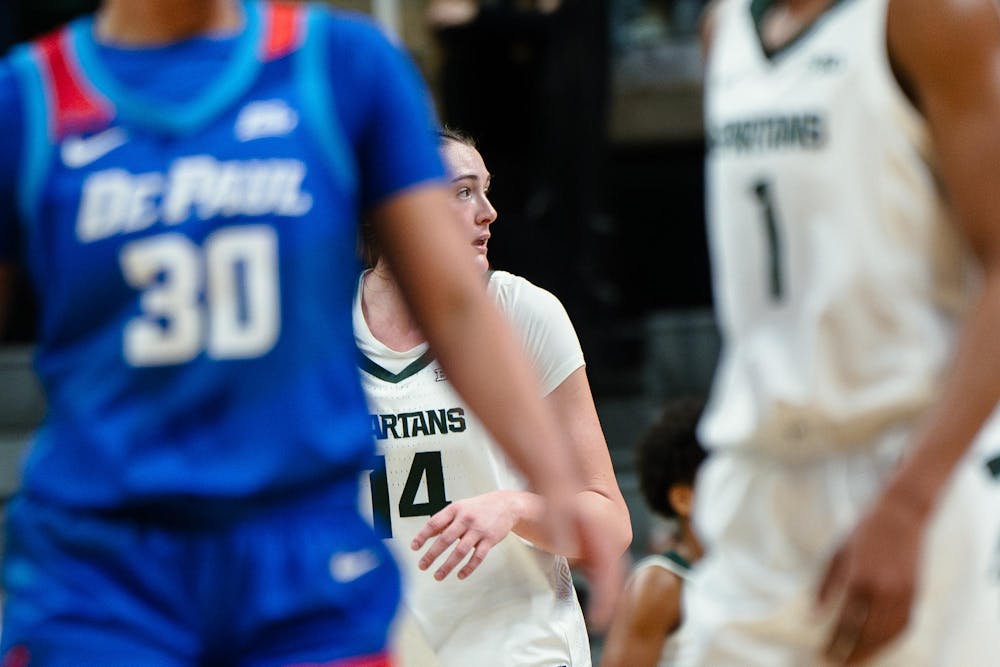 Michigan State junior forward Grace Vanslooten (14) looks across the court at the Breslin Center during the game against DePaul University on Dec. 8, 2024. The Spartans won 89-61 against the Blue Demons, starting the season 9-0 for the first time in program history. 