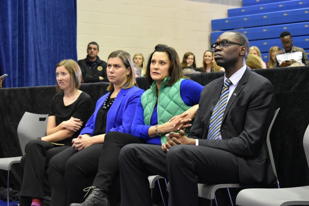 Democratic congressional candidate Elissa Slotkin, gubernatorial candidate Gretchen Whitmer, and candidate for lieutenant governor Garlin Gilchrist II watch former Vice President Joe Biden speak at LCC on Nov. 1.