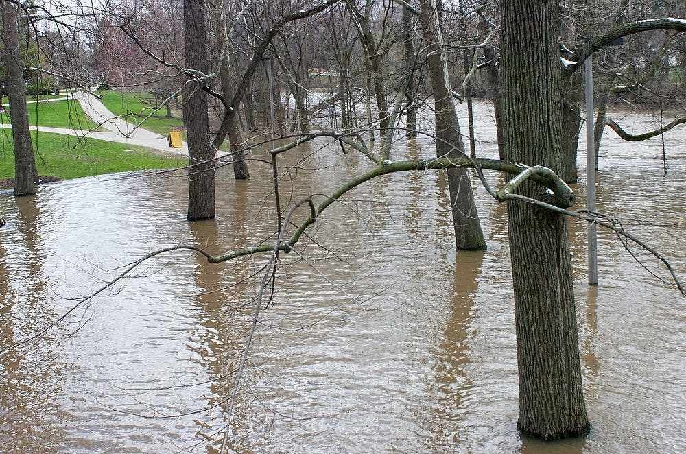 	<p>Red Cedar River overflows into the north bank outside Main Library and Administration building, Saturday, April 20, 2013. Justin Wan/The State News</p>