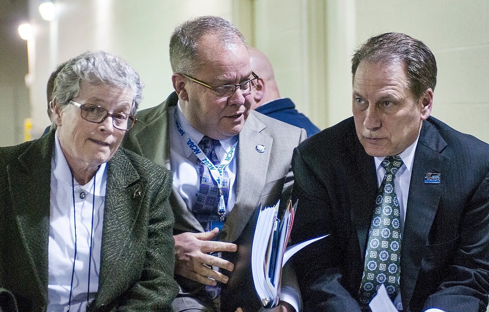 <p>From left, MSU President Lou Anna K. Simon, athletics director Mark Hollis, and head coach Tom Izzo talk with one another following the loss Friday, March. 29, 2013, at Lucas Oil Stadium in Indianapolis, Ind. The Duke Blue Devils defeated the Spartans, 71-61, in the Sweet Sixteen of the NCAA Tournament and now advance to the Elite Eight. Adam Toolin/The State News</p>