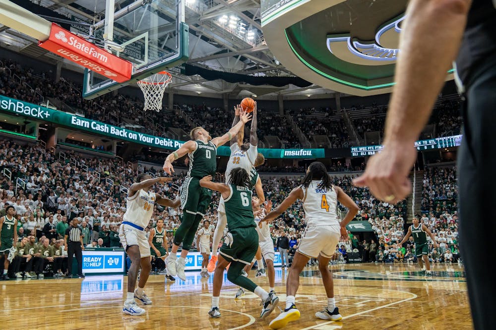 <p>MSU forward and senior Jaxon Kohler (0) jumps to swat the ball out of a SJSU player's hands at the Breslin Center in East Lansing, Michigan on Thursday, Nov. 13, 2025.</p>