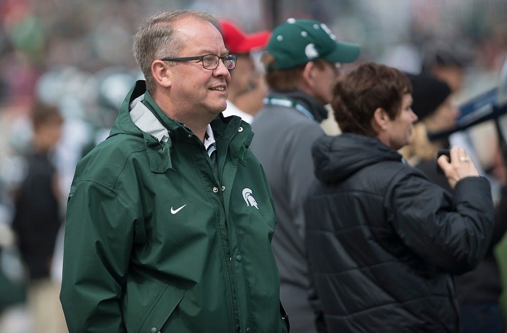 <p>Athletic director Mark Hollis watches the team on the field April 25, 2015, during the Green and White Spring Game at Spartan Stadium. The White team defeated the Green team, 9-3.</p>