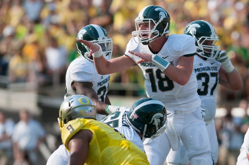 <p>Junior quarterback Connor Cook communicates with his team during the game against Oregon on Sept. 6, 2014, at Autzen Stadium in Eugene, Ore. The Spartans lost to the Ducks, 46-27. Julia Nagy/The State News</p>