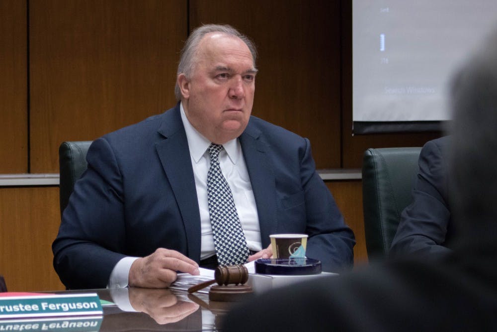 MSU Interim President John Engler listens during public comment at the Board of Trustees meeting on Oct. 26, 2018.
