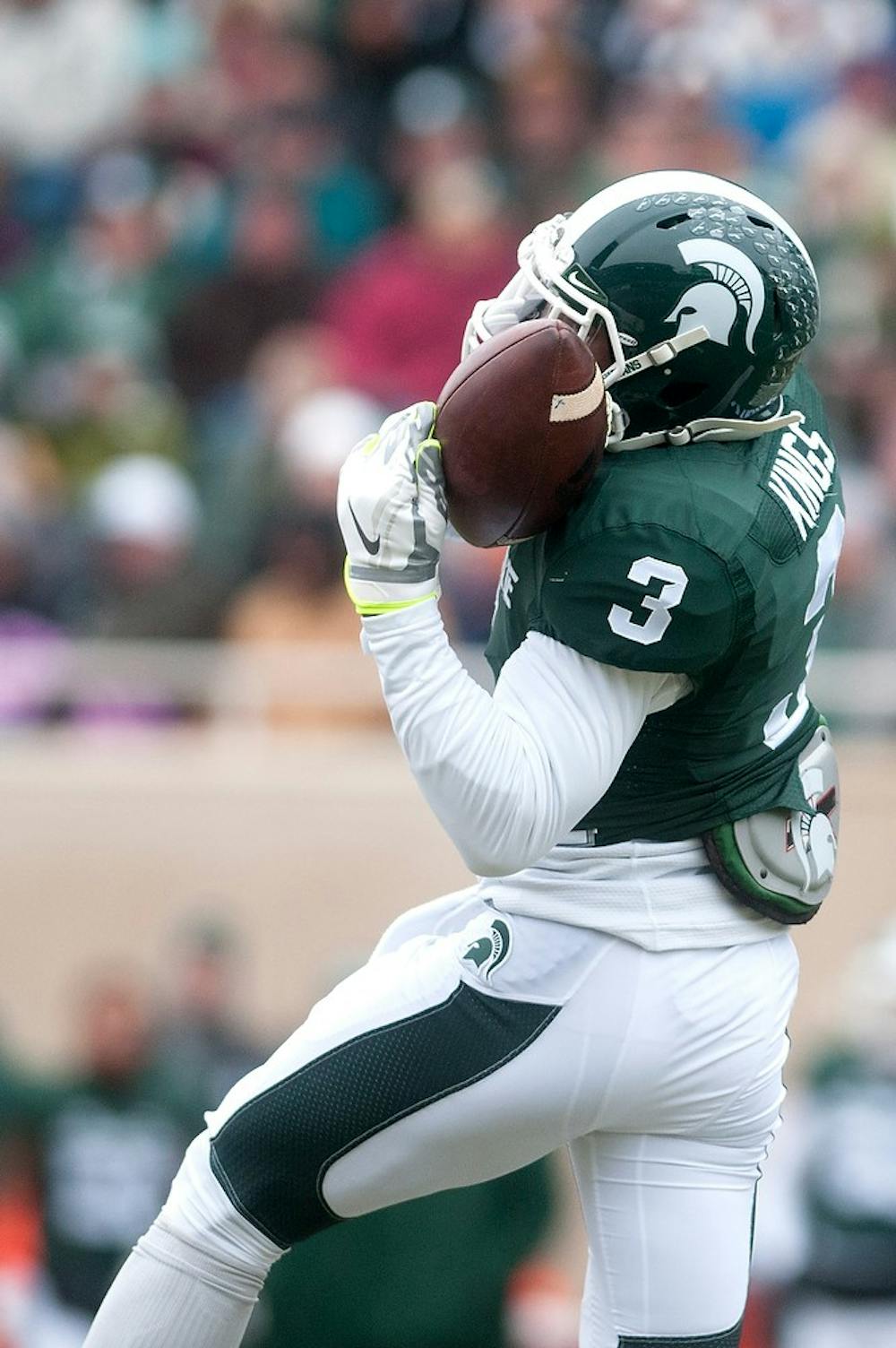 <p>Junior wide receiver Macgarrett Kings Jr. nearly fumbles the ball Nov. 22, 2014, during the game against Rutgers at Spartan Stadium. The Spartans defeated the Scarlet Knights, 45-3. Jessalyn Tamez/The State News </p>